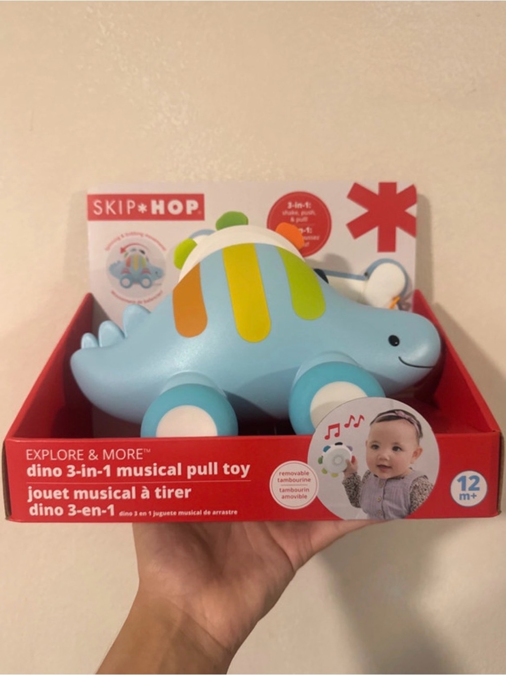 Skip Hop Light Blue Dinosaur Pull Toy with Yellow and Orange Stripes